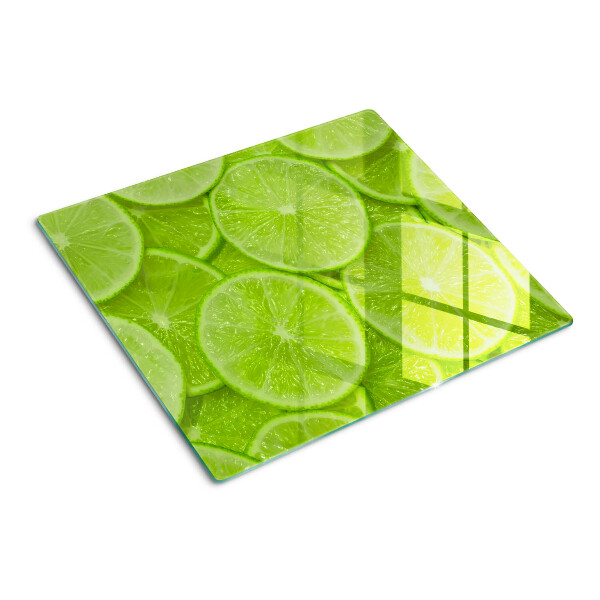 Tocător de bucătărie Felii de lime pe fundal verde