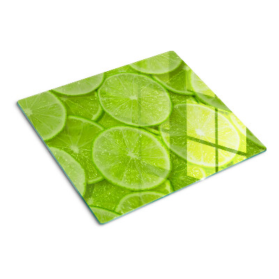Tocător de bucătărie Felii de lime pe fundal verde