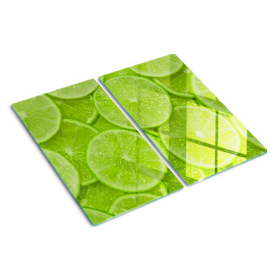 Tocător de bucătărie Felii de lime pe fundal verde