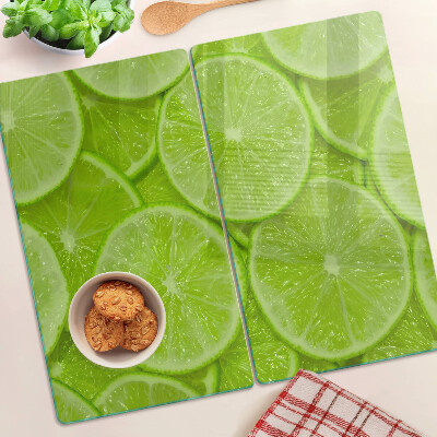 Tocător de bucătărie Felii de lime pe fundal verde