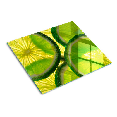 Tocător sticlă Felii de lime pe fundal verde