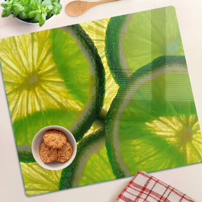 Tocător sticlă Felii de lime pe fundal verde