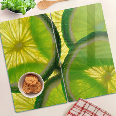 Tocător sticlă Felii de lime pe fundal verde