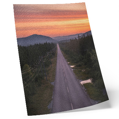 Poster în culori saturate Un drum drept prin pădure într-un apus de soare pastelat